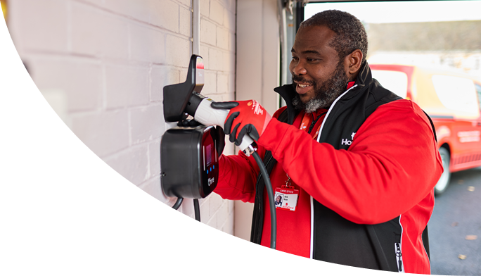 A HomeServe electrician testing a home EV charger after a repair