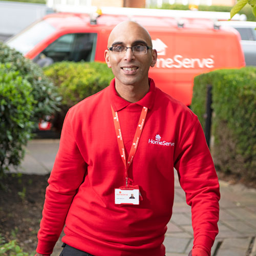 HomeServe engineer arriving at house HomeServe engineer outside home with toolkit